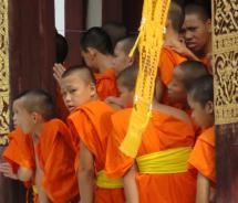 Buddhist monks and novices snap photos of the festivities. // (c) 2011 Monica Poling