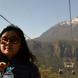 Vicky Qin, a tour director for Globus Family of Brands, on a gondola to Jade Dragon Snow Mountain’s Spruce Meadow in Lijiang, China // © 2013 Mindy Poder