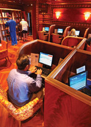 Onboard the Carnival Miracle, clients can check in with friends and family in the Raven Library. // (c) Carnival Cruise Line