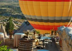 A hot-air balloon rises over the Museum Hotel in Cappadocia, Turkey. // (C) 2010 Museum Hotel Cappadocia