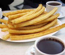 Chocolateria San Gines serves churros — long, lightly oiled, crispy fried dough straight from the kitchen to the table — with thick hot chocolate. // © 2011 Mindy Poder