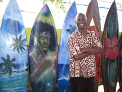 Surfboard artist Ron Artis in front of his painted boards. // (c) Kathy Leong