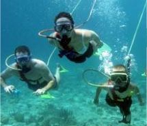 Three people underwater doing snuba // © 2010 Trilogy Ocean Sports