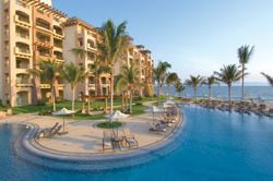 Deck chairs line the freeform swimming pool. // (c) villa group resorts