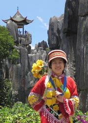 Travelers can try on traditional garments and pose in front of this pagoda built on top of the Stone Forest near Kunming. // © 2009 Eric Chan