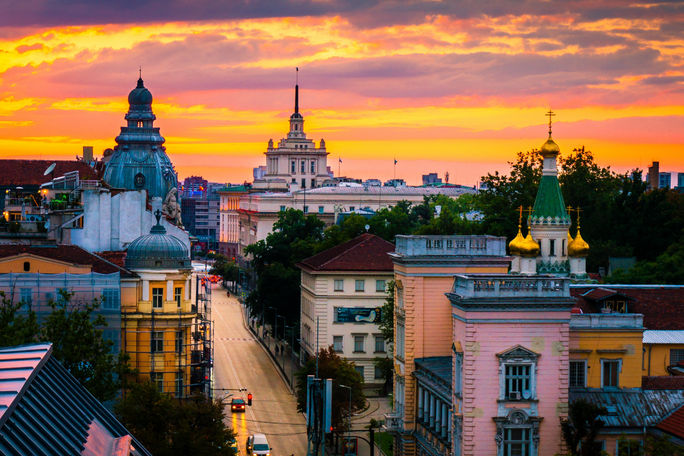 Sofia in Orange Sofia, capital of Bulgaria on a sunset, magnificent view from above over the historical buildings (photo via sfabisuk / iStock / Getty Images Plus)