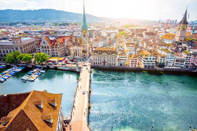 Aerial panoramic cityscape view on the old town of Zurich city in Switzerland (photo via RossHelen / iStock / Getty Images Plus)