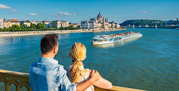 A couple looks out over the river.