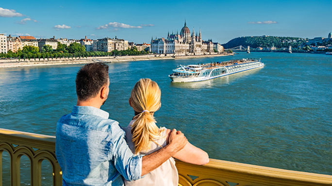 A couple looks out over the river.