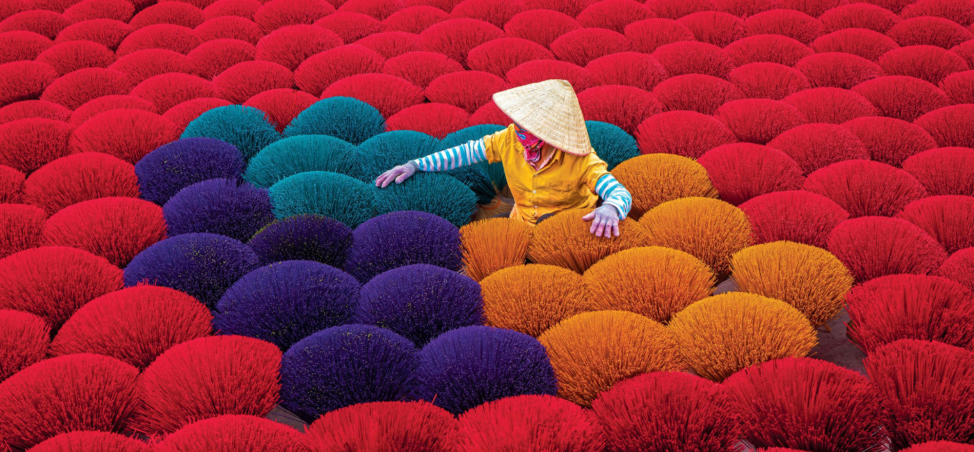 Image: A worker is drying traditional incense sticks at Cau Bau market, Thanh Oai, Ha Noi, North Vietnam. (Photo Credit: Grand Circle Corporation)