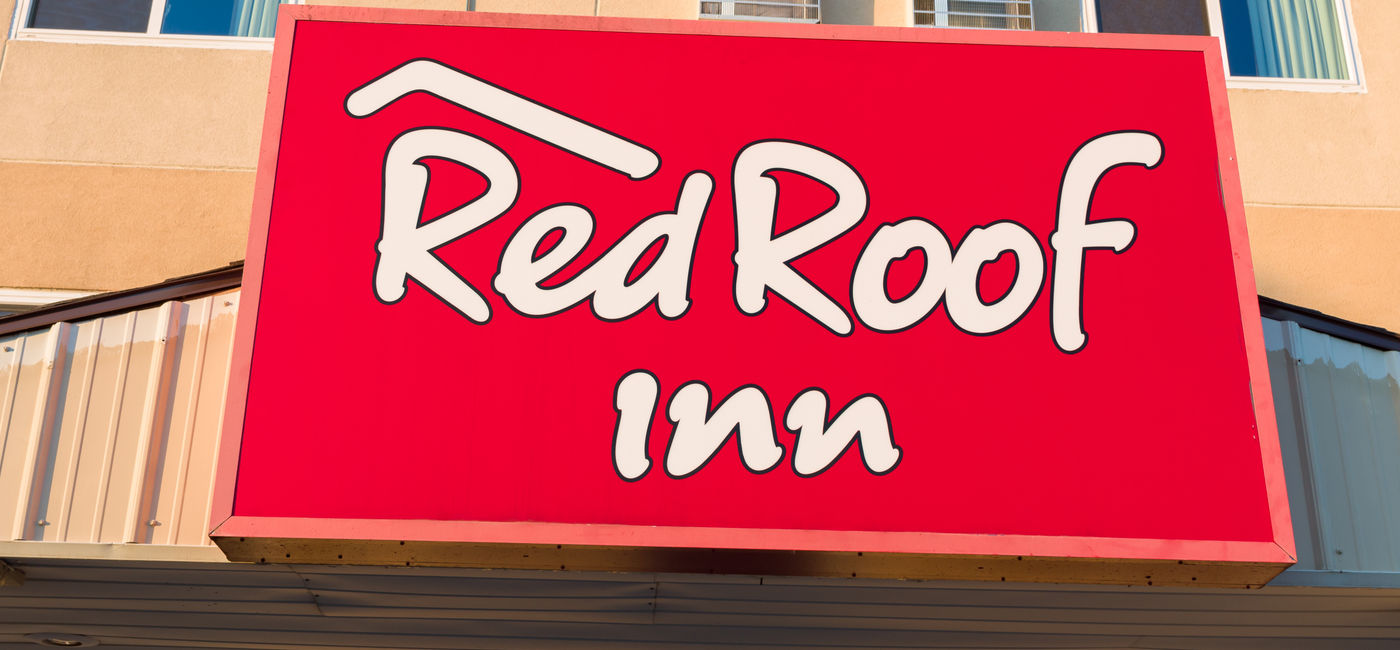 Image: Red Roof Inn exterior sign. (Photo Credit: wolterke / Adobe Stock)