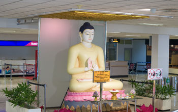 A sculpture of a seated Buddha welcoming passengers at Bandaranaike International Airport