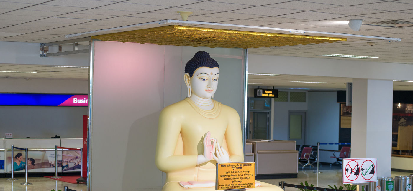 Image: A sculpture of a seated Buddha welcoming passengers at Bandaranaike International Airport. (Photo Credit: Adobe/sikaraha)