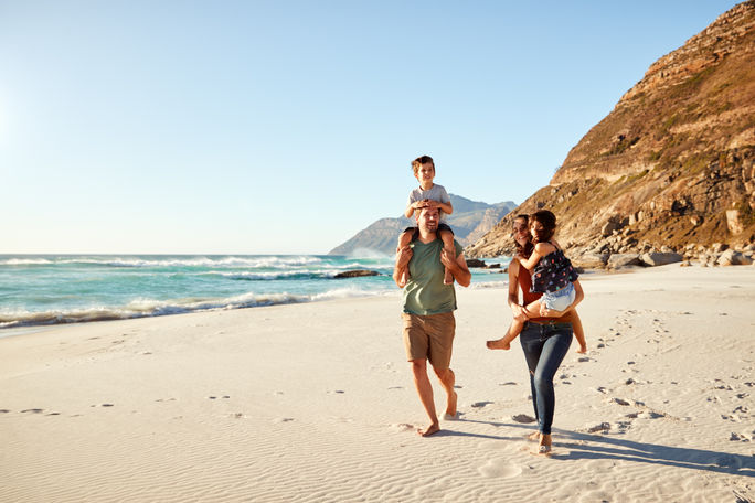 Family travelers walking along the beach Family travelers walking along the beach