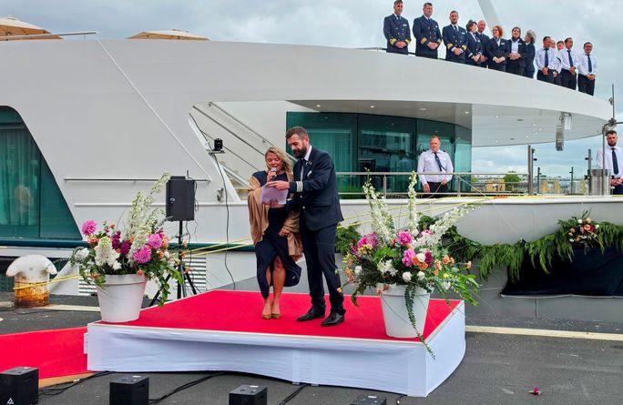 Ship's godmother, Kristie Keller, speaks to attendees during Amadeus Aurea's christening ceremony. Ship's godmother, Kristie Keller, speaks to attendees during Amadeus Aurea's christening ceremony.