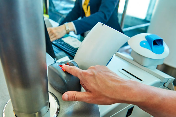 Passenger using biometric technology at the airport.