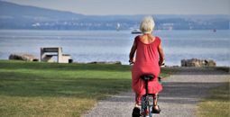 Senior on a bicycle at the beach