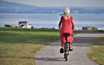 Senior on a bicycle at the beach