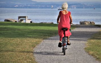 Senior on a bicycle at the beach