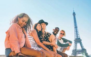 Young Contiki travelers at the Eiffel Tower in Paris