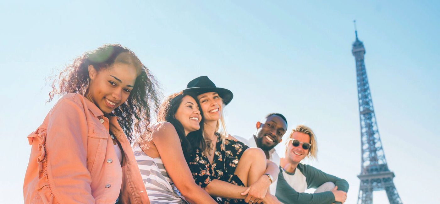 Image: Young Contiki travelers at the Eiffel Tower in Paris (Photo Credit: Contiki)