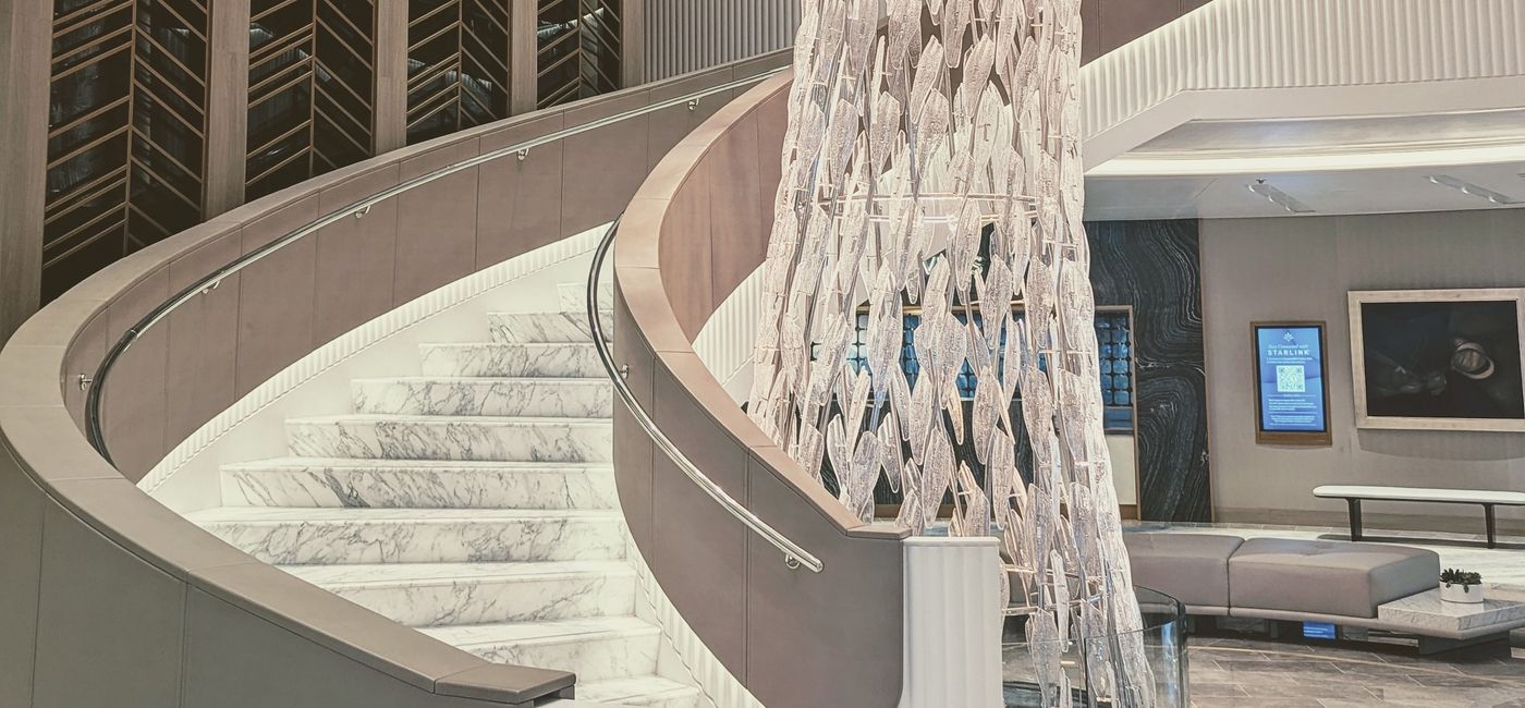 Image: Le grand escalier de l’Oceania Allura (Photo Credit: Claudette Covey)