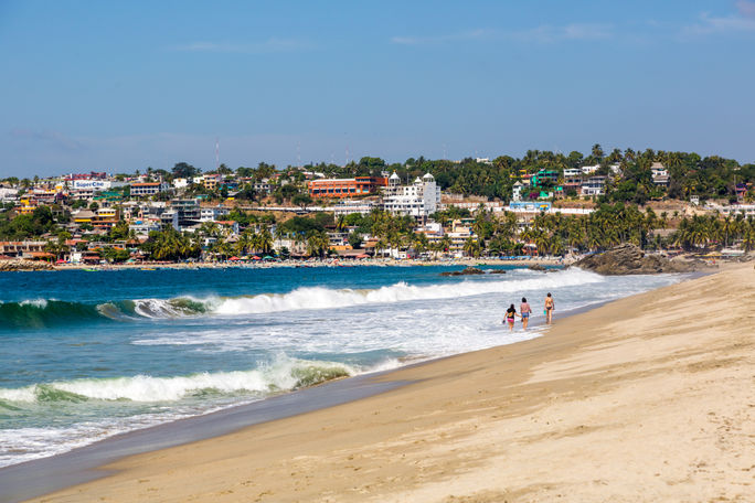 People on the beach in Puerto Escondido, Mexico People on the beach in Puerto Escondido, Mexico