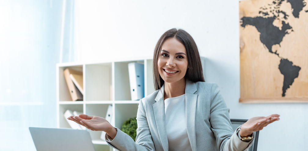 A travel advisor welcoming clients to her agency.