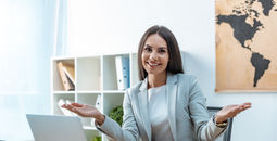 A travel advisor welcoming clients to her agency.