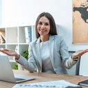 A travel advisor welcoming clients to her agency.