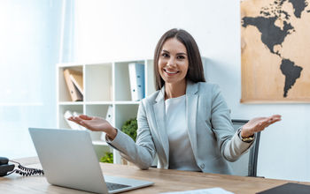 A travel advisor welcoming clients to her agency.