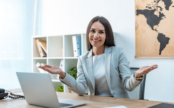 A travel advisor welcoming clients to her agency.