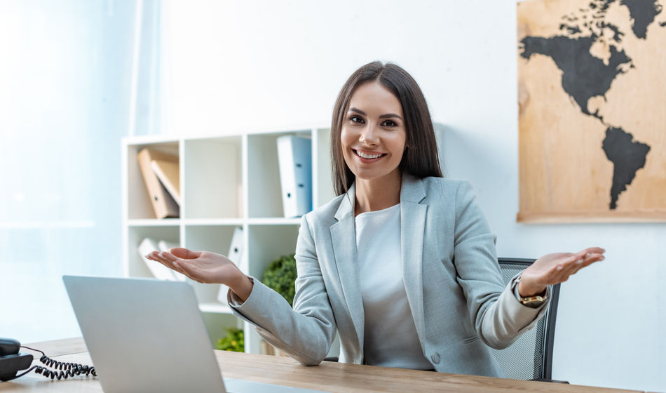 A travel advisor welcoming clients to her agency.