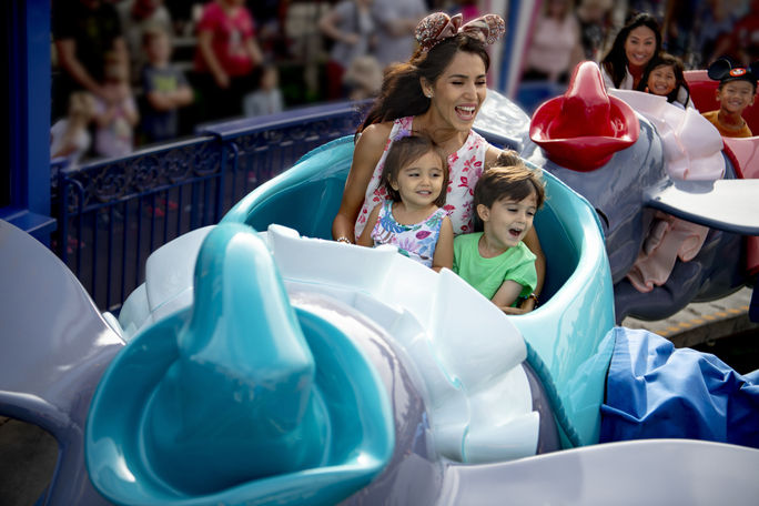 Disneyland guests riding the Dumbo the Flying Elephant attraction.