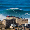 Surfer riding a giant wave in Nazare, Portugal 