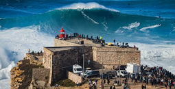 Surfer riding a giant wave in Nazare, Portugal 