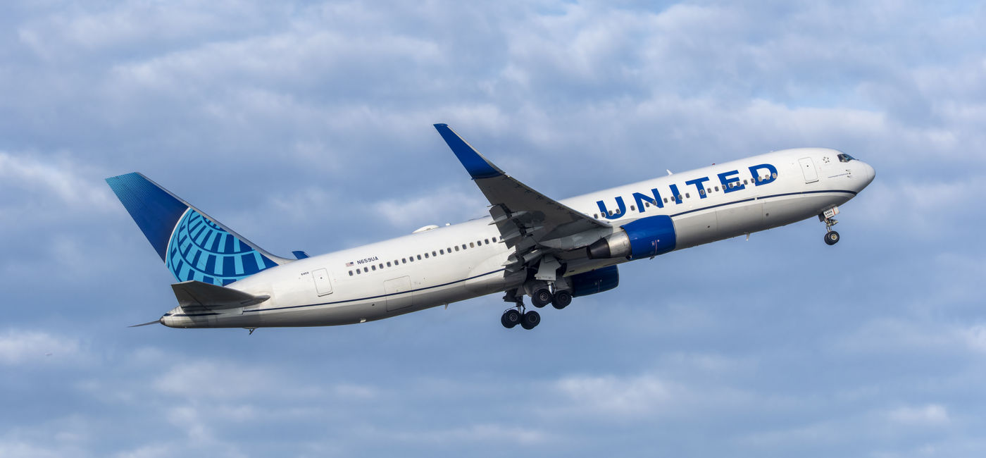 Image: United Airlines airplane in flight. (Photo Credit: Adobe Stock/hectorchristiaen)