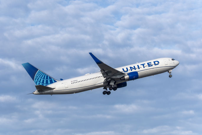 United Airlines airplane in flight. United Airlines airplane in flight.