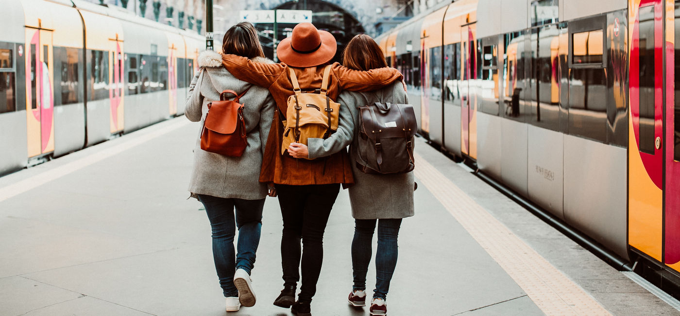 Image: A group of young friends waiting at the station in Porto, Portugal before catching a train. (Photo Credit: lubero/Adobe Stock)