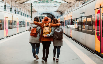 A group of young friends waiting at the station in Porto, Portugal before catching a train.