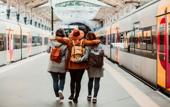 A group of young friends waiting at the station in Porto, Portugal before catching a train.