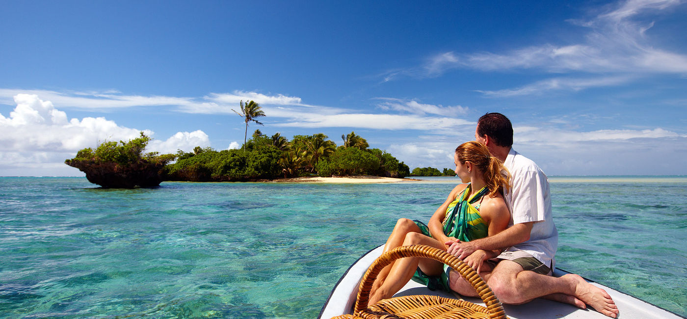 Image: A couple on a boat in Fiji headed to a private island. (photo via Fiji Airways)