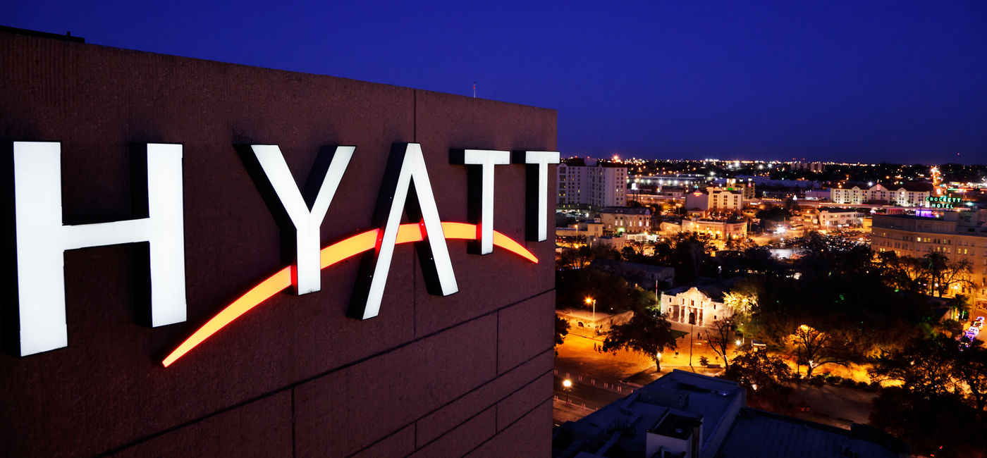 Image: Hyatt hotel marquee above San Antonio, Texas.  (Photo Credit: Adobe Stock/Jo Ann Snover)