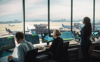Air traffic controllers working in an airport control tower.