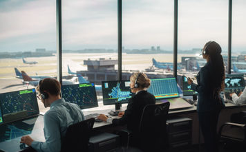 Air traffic controllers working in an airport control tower.