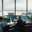 Air traffic controllers working in an airport control tower.