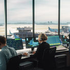 Air traffic controllers working in an airport control tower.