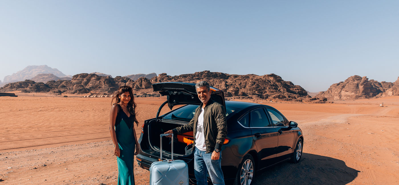 Image: A Daytrip traveler getting picked up by a driver in the desert. (Photo Credit: oneworldjustgo.com / Daytrip)