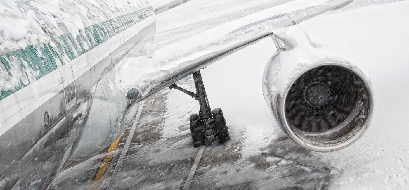 Image: Airplane covered in snow and ice during a winter storm. (Photo via iStock/Getty Images Plus/nycshooter)