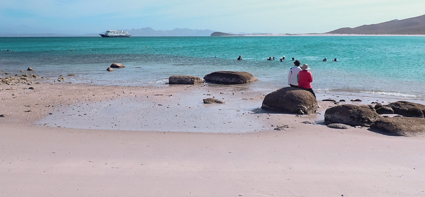 Image: A couple on an UnCruise Adventures enjoys the beach in Baja, Mexico. (photo via UnCruise Adventures) (Photo Credit: (photo via UnCruise Adventures))
